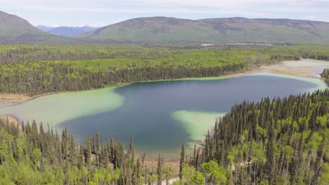 drone footage of deforestation in the canadian forest. river running next to the mountains in a village of indiginous tribes