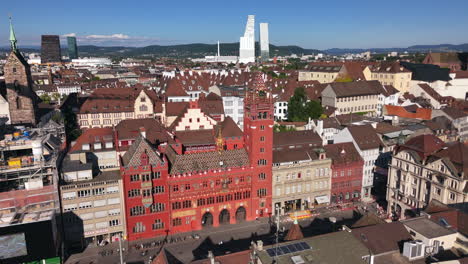 basel city center with historic red rathaus and modern buildings in the distance, aerial view