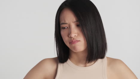 asian woman looking offended on camera.