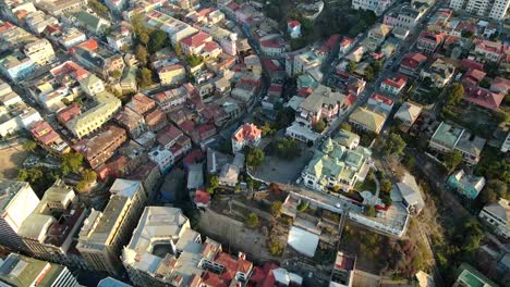 aerial dolly out baburizza palace, yugoslavian walk and el peral funicular in cerro alegre, valparaiso, chile