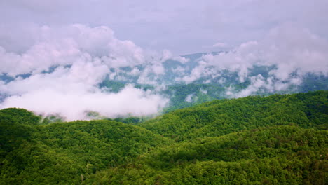 serene and cinematic drone view of misty peaks.