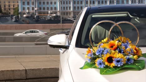 wedding car decorated with flowers and rings