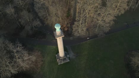 Ashridge-estate-Bridgewater-monument-aerial-top-down-view-tilting-up-across-National-trust-woodland-trees