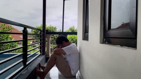 man sitting on the floor and leaning on the wall