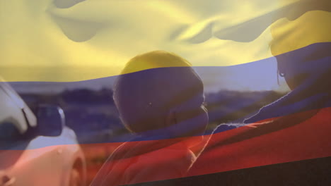 animación de la bandera de colombia sobre madre caucásica con bebé en la playa