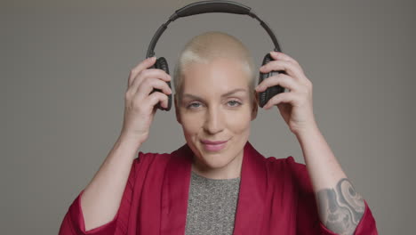 female model placing headphones on her head