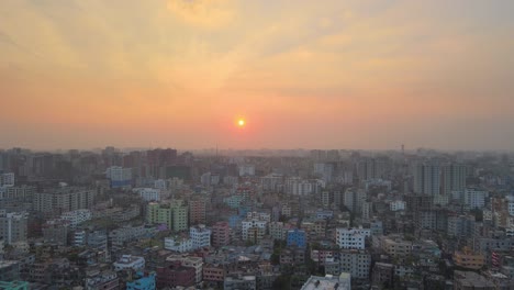 aerial over khilgaon thana cityscape with hazy orange sunset skies