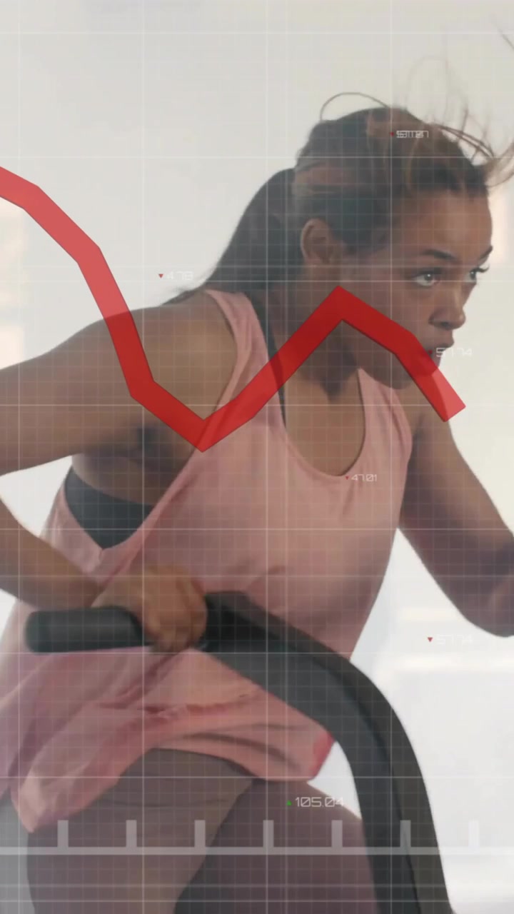 Donna che si allena su cyclette, con animazione di grafico di borsa sovrapposta