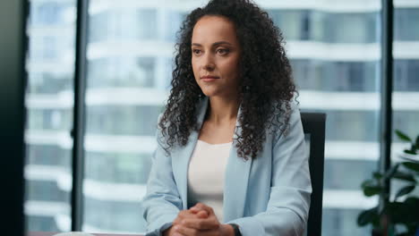 Confident-woman-working-office-sitting-at-desk-close-up.-Portrait-businesswoman.