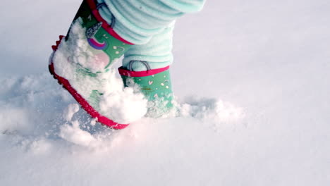 Slow-motion-shot-of-young-girl-walking-through-the-snow