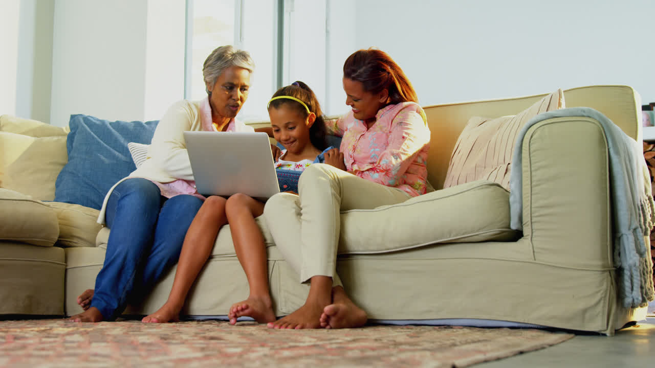 Happy family using laptop in living room 4k