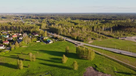 Aerial view of Katlakalns in spring with traffic, houses, and lush greenery