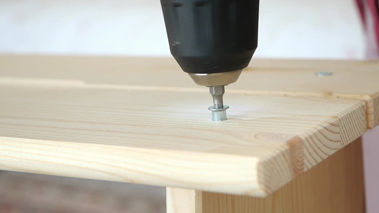 Drilling a screw into wood