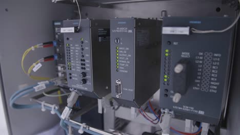 industrial control panel with siemens hardware showing various status lights and cable connections