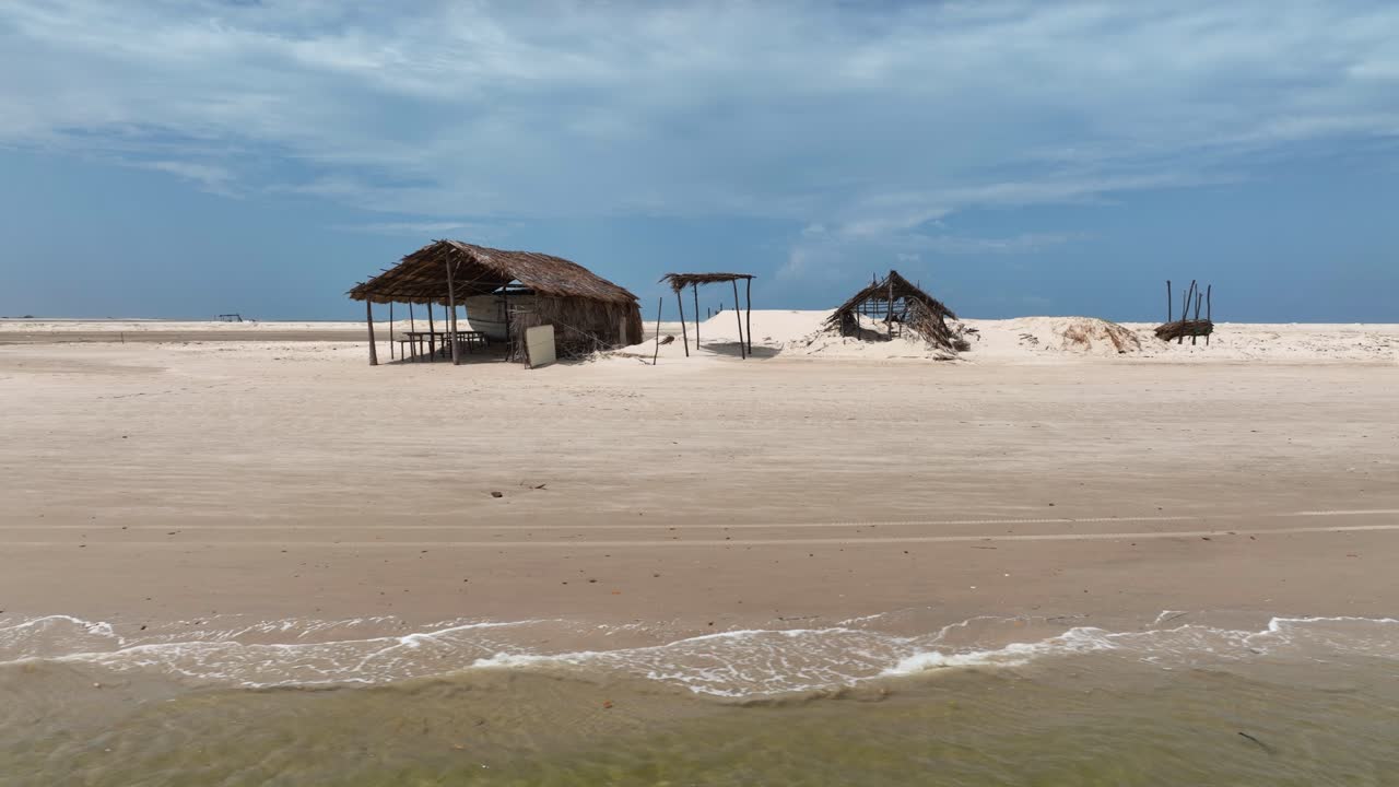 Thatched Roof Huts In The Sandy Beach In Summer. - aerial shot