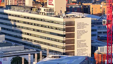 Zoomed-drone-lifting-shot-of-Sheffield-Hallam-University-during-sunrise