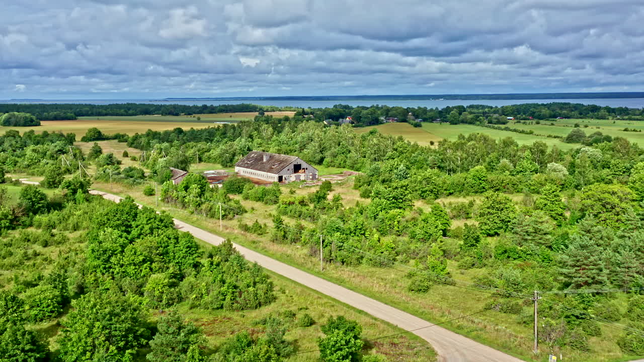 Aerial View of Green Rural Landscape with the Sea in the Background - Backwards Dolly Shot