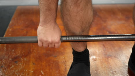 man performs a deadlift set during a weight training session