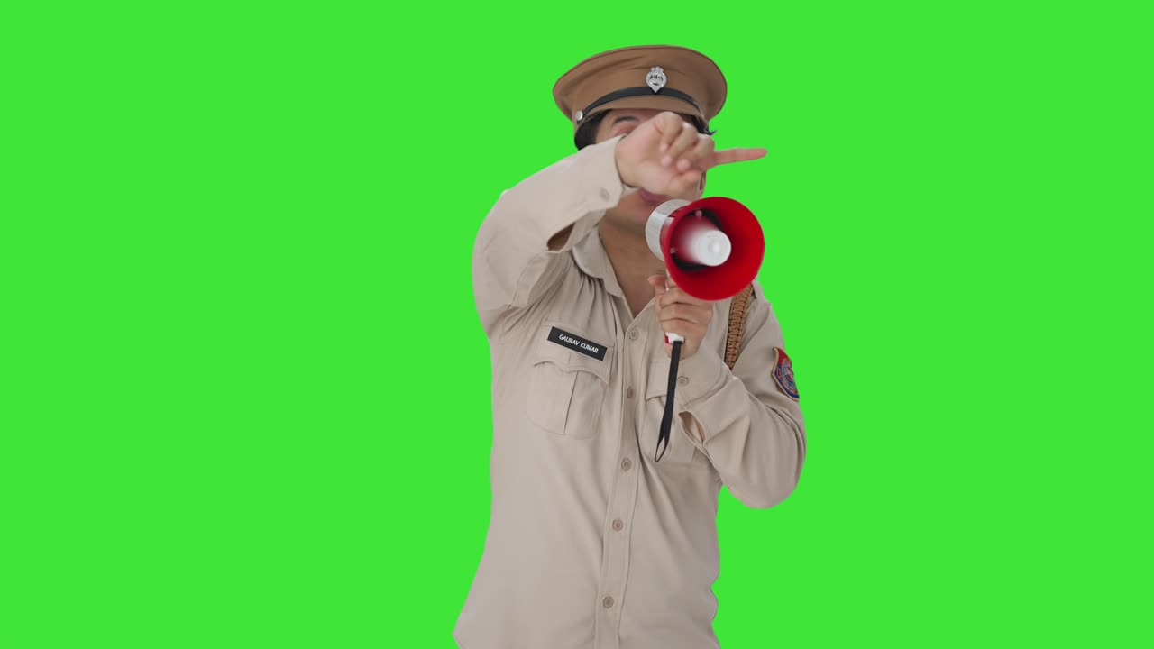 메가폰 그린 스크린을 사용하여 까마귀를 통제하는 인도 경찰관