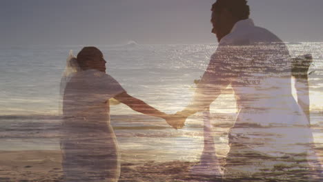 animation of sea over married african american couple at beach