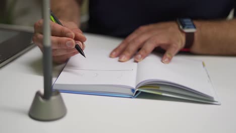 graphic designer sketching in notebook