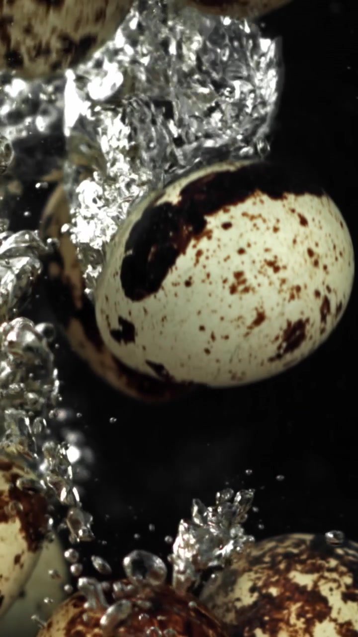 Quail Eggs Boiling in Water with Rising Bubbles