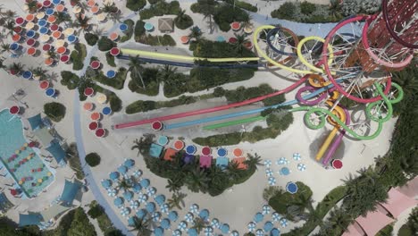 Aerial-tilts-to-huge-waterslide-tower-in-Thrill-Waterpark,-Coco-Cay