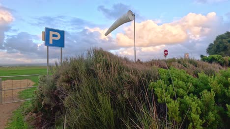 a windsock flutters in a scenic landscape along the great ocean road, capturing the serene beauty of nature