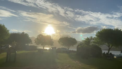 Sunset-over-campsite-with-tents,-camping-and-green-trees,-quaggas,-Cape-Town