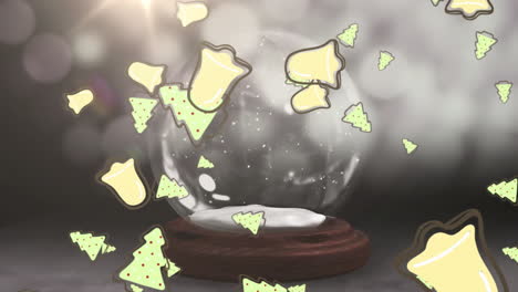 árboles de navidad y iconos de campanas cayendo contra las estrellas fugaz alrededor del globo de nieve en fondo gris