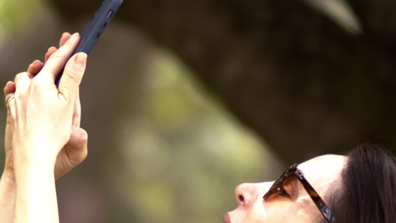 Restricted slow motion close-up scenery, brunette female, smartphone