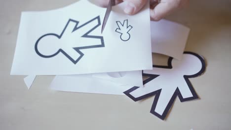 scissors cutting different paper silhouettes for april fools day