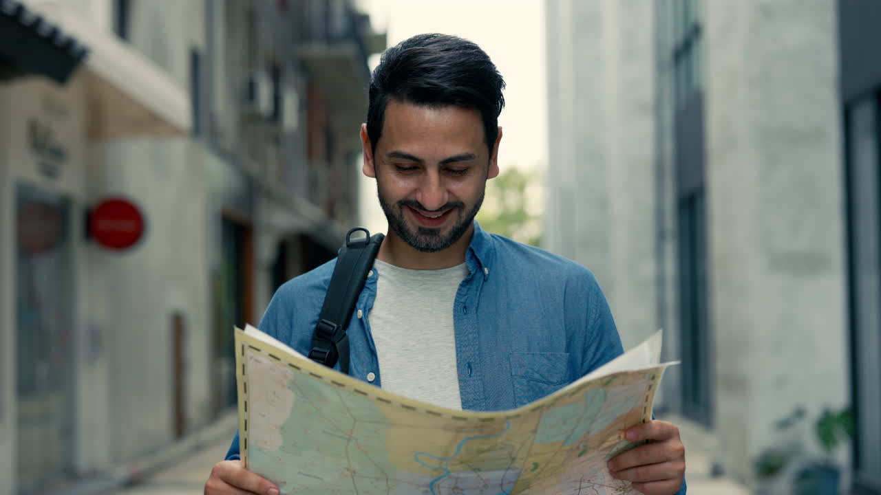 Happy Man Exploring City Street with a Map