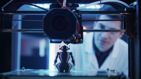 a close-up view of a 3d printer in action, showcasing the detailed process of creating a small figure with an enthusiastic observer in the background