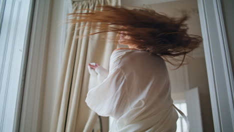 Smiling-girl-dancing-cozy-place-closeup.-Positive-woman-looking-camera-spinning