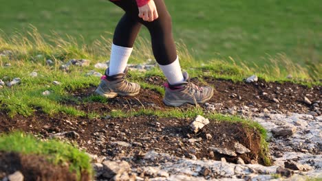 Girl-carefully-descending-a-steep-rocky-hill,-in-the-Peak-District,-England