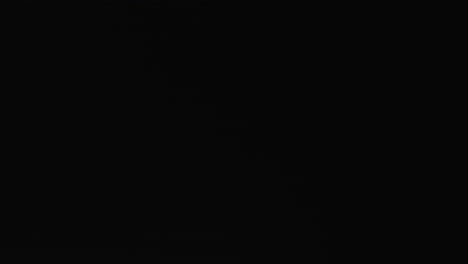 white rugby ball on black background with copy space, slow motion