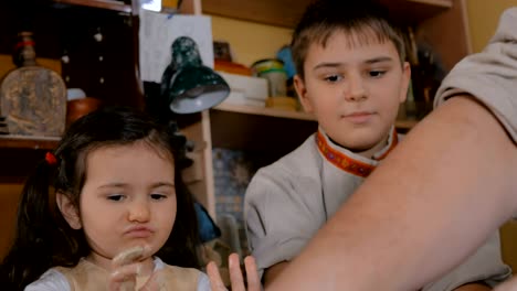 potter showing how to work with ceramic in pottery studio