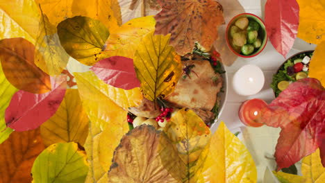 animation of autumn leaves over thanksgiving dinner background