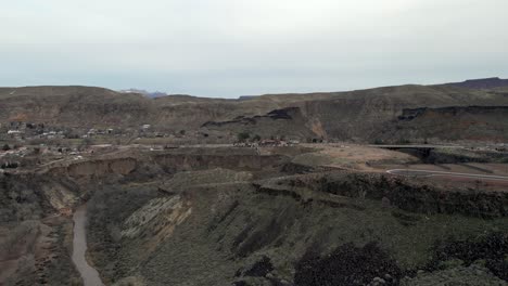 La,-Verkin,-Utah-and-state-route-17-along-the-cliffs-over-the-muddy-Virgin-River---aerial-flyover