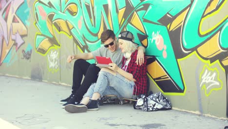 affectionate hipster urban couple relaxing in town