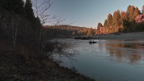 silhouette of a sailing boat on quiet smith river at humbolt county in california during fall season