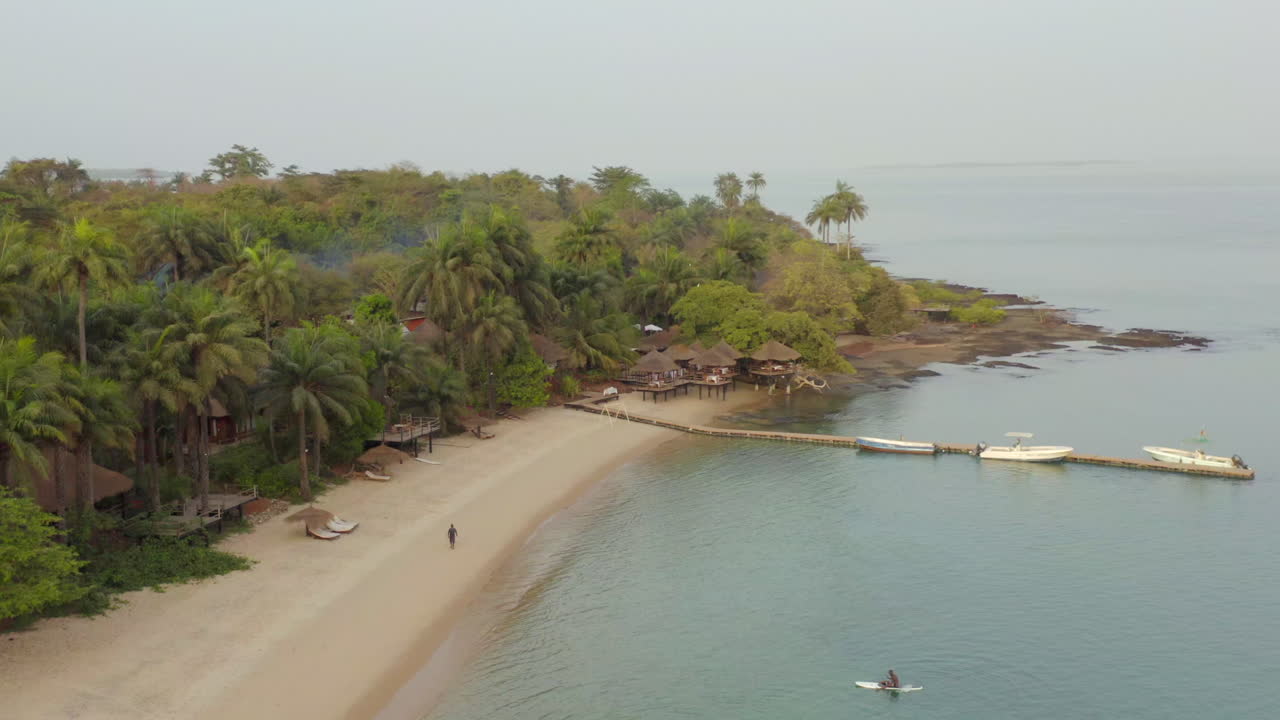 Quiet Sandy Beach with Palm Trees and Pier – Guinea-Bissau