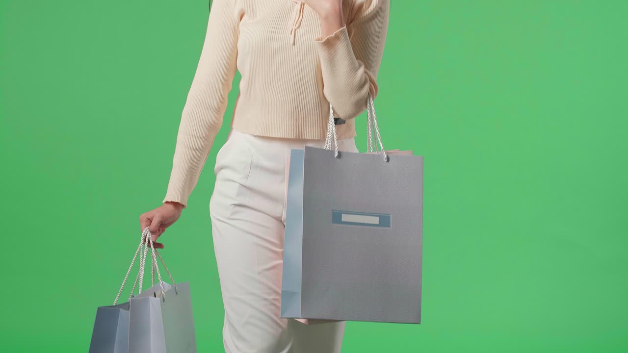 Asian Shopping Woman With Shopping Bags Smile And Walking In Front Of Green Screen