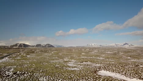 cinematic drone shot over the iceland landscape near selfoss with mountains in the distance