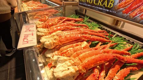 customers browsing fresh king crab legs display.