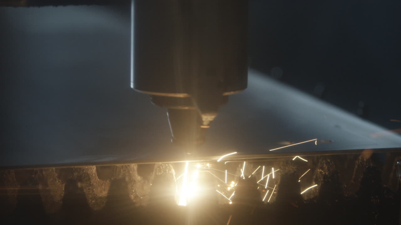 Sparks glow and fly as a power tool cuts and shapes metal