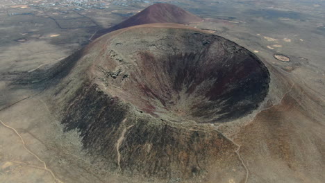 aerial view of a volcano crater in a desert landscape