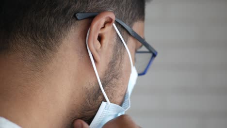 man wearing glasses and a mask