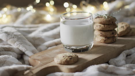 Video-of-christma-cookies,-glass-of-miljk-and-copy-space-on-white-background